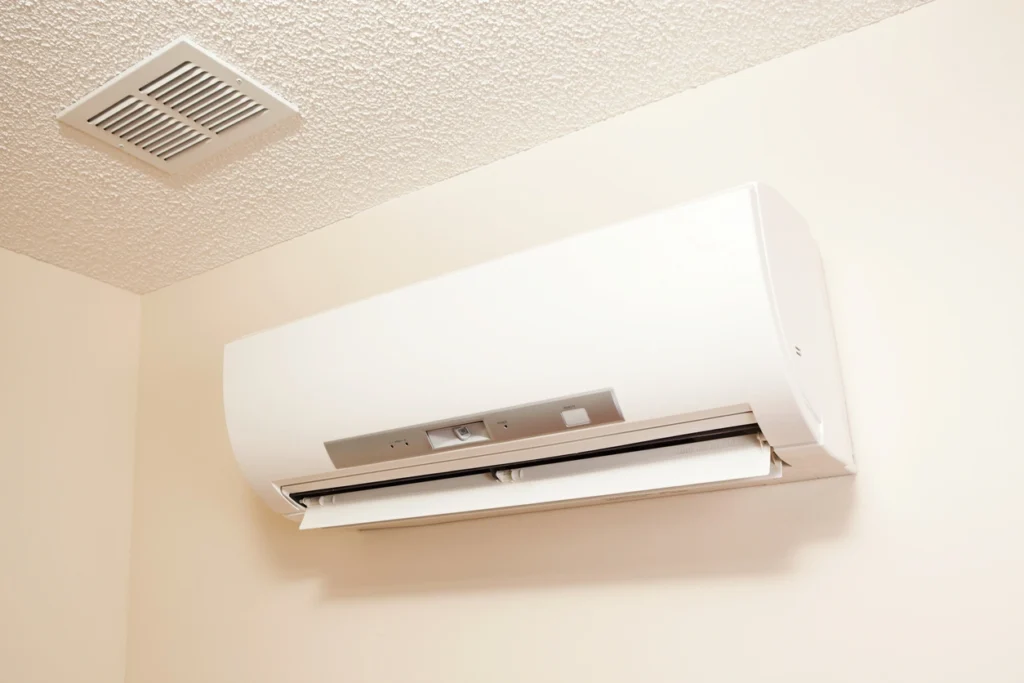 Ductless Ac A white air conditioner installed on a wall, providing efficient cooling for the room.